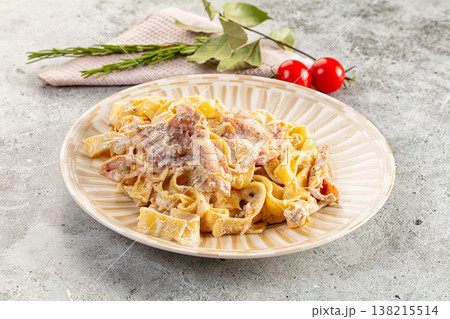 Italian pasta fettuccine with prosciutto Italian pasta fettuccine with prosciutto 138215514