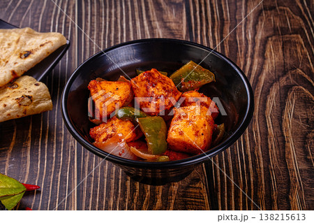 Indian Paneer Tikka Masala inl with Roti bread on a dark wooden table 138215613