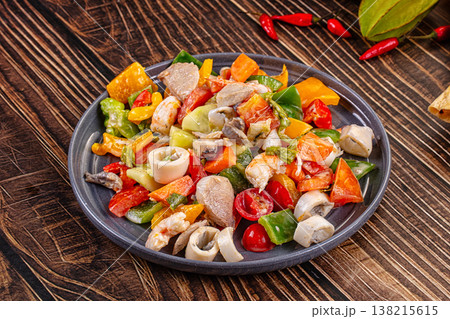 Fresh seafood and vegetable salad with shrimp, tuna and calamari next to flatbread and raw ingredients. Fresh seafood and vegetable salad with shrimp, tuna and calamari next to flatbread and raw ingredients. 138215615