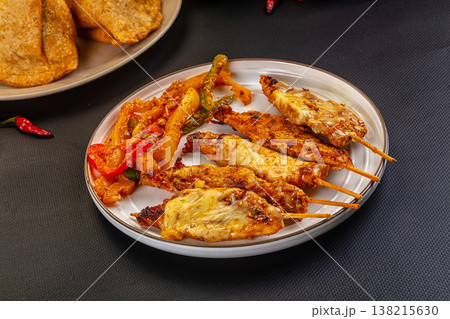 Grilled Chicken Skewers with Melted Cheese and Sauteed Vegetables 138215630