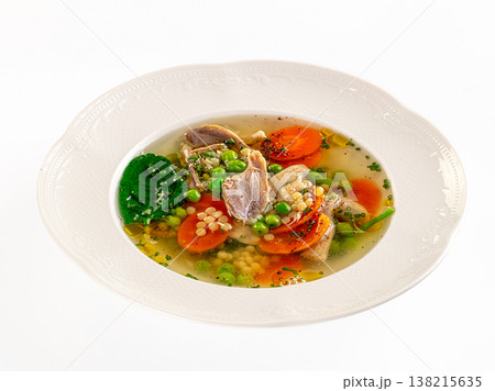 Gourmet chicken soup with fresh vegetables and pasta in a white ceramic bowl on a white background Gourmet chicken soup with fresh vegetables and pasta in a white ceramic bowl on a white background 138215635
