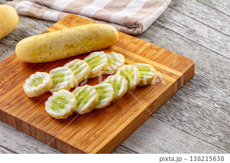 Freshly Sliced Yellow Cucumbers on a Wooden Cutting Board Freshly Sliced Yellow Cucumbers on a Wooden Cutting Board 138215638