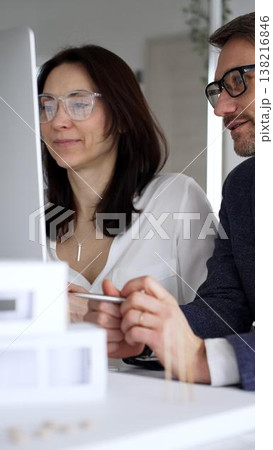 Professional female architect and male engineer collaborating, planning, and discussing a housing project in the office. Business people and architecture concept Professional female architect and male engineer collaborating, planning, and discussing a housing project in the office. Business people and architecture concept 138216846