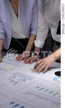 Business professionals analyzing financial data and marketing reports on a white desk, collaborating on project strategy and reviewing company performance with charts and diagrams 138216927