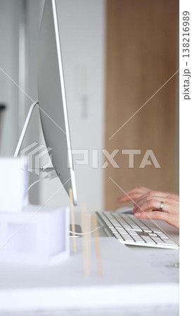 Architect working on building blueprint plans, designing new projects with computer and drawing tools. Business and architecture concept Architect working on building blueprint plans, designing new projects with computer and drawing tools. Business and architecture concept 138216989