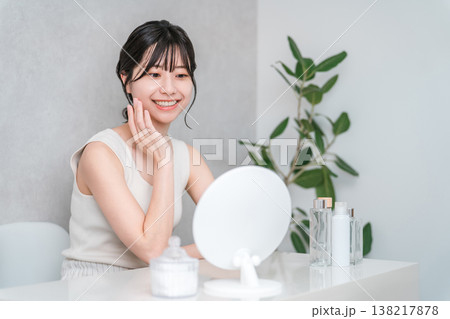 鏡を見て美容,スキンケア,フェイシャルケアをする若いアジア人女性 138217878