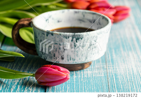 Spring composition with a cup of coffee and tulips. Spring composition with a cup of coffee and tulips. 138219172