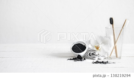 Composition with bamboo toothbrushes, teeth whitening powder and orchid flower. Composition with bamboo toothbrushes, teeth whitening powder and orchid flower. 138219294