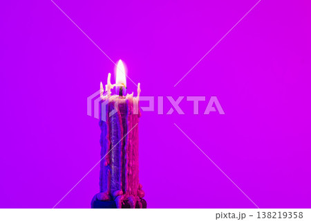 Texture vintage candle on a pink background with neon lighting, copy space. Texture vintage candle on a pink background with neon lighting, copy space. 138219358