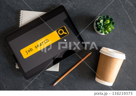 Top view of digital tablet with search job on screen. 138219373