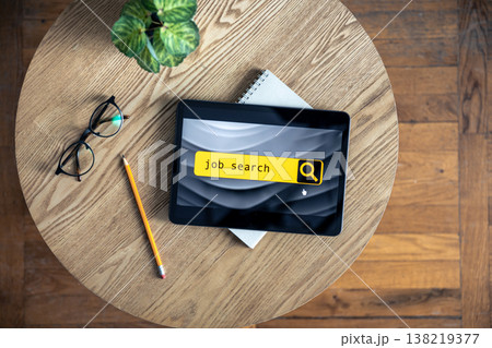 Top view of digital tablet with search job on screen on a table. Top view of digital tablet with search job on screen on a table. 138219377