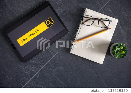 Top view of digital tablet with search job on screen on a table. 138219380