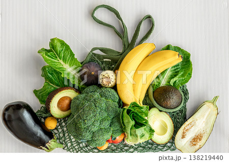 A variety of fresh vegetables and fruits on a white background, flat lay. A variety of fresh vegetables and fruits on a white background, flat lay. 138219440