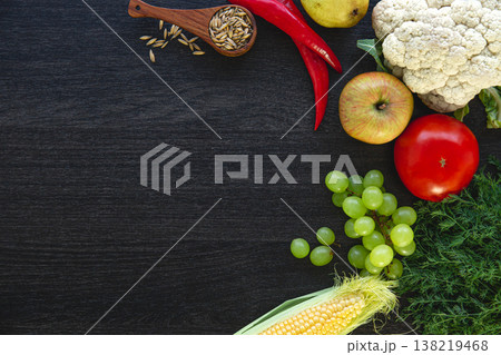 Vegetables and fruits on a dark wooden background, flat lay. Vegetables and fruits on a dark wooden background, flat lay. 138219468