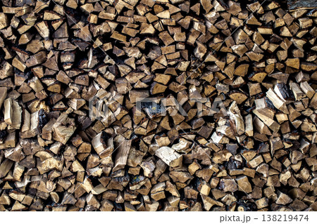 very large pile of firewood, stacked in an old barn very large pile of firewood, stacked in an old barn 138219474
