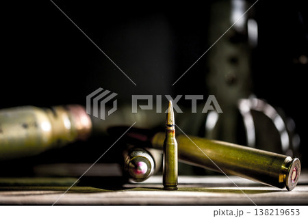 weapons, cartridge on wooden background weapons, cartridge on wooden background 138219653