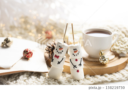 Winter composition with a cup of cocoa and marshmallows on a blurred background. Winter composition with a cup of cocoa and marshmallows on a blurred background. 138219730