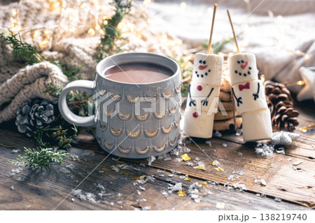 Winter composition with a cup of cocoa and marshmallow snowmen. Winter composition with a cup of cocoa and marshmallow snowmen. 138219740