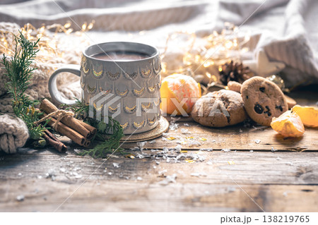 Winter composition with a cup of coffee, cinnamon and cookies. Winter composition with a cup of coffee, cinnamon and cookies. 138219765