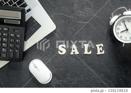 Wooden text Sale and calculator on black textured background, top view. Wooden text Sale and calculator on black textured background, top view. 138219818