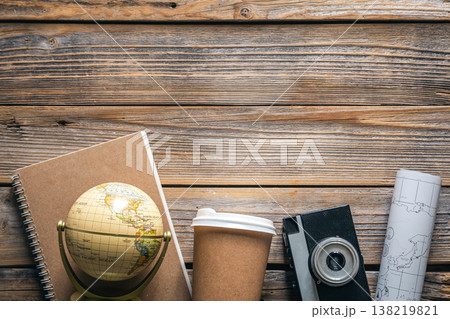 Wooden travel background with globe, map, camera and coffee, top view. Wooden travel background with globe, map, camera and coffee, top view. 138219821