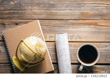 Wooden travel background with globe, map and coffee cup, top view. 138219822