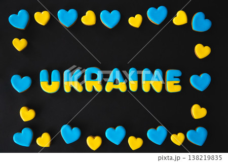 The word Ukraine on a black background, made with handmade gingerbread. The word Ukraine on a black background, made with handmade gingerbread. 138219835