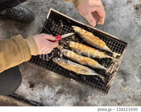 the process of roasting juicy and spiced fresh mackerel on a grill, mackerel on coals on a grill recipe 138221030