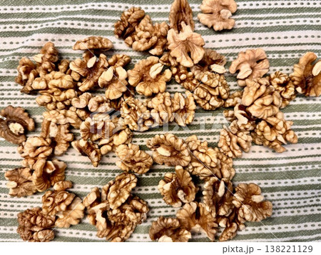 A washed, peeled walnut is lying on a cotton kitchen towel A washed, peeled walnut is lying on a cotton kitchen towel 138221129