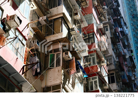 old crowded residential apartment building facades with air conditioners in Hong Kong 138221775