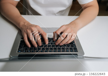 Close-up of male hands typing on laptop keyboard, working remotely from home, connecting online, processing data, coding, managing business, browsing internet, digital communication. Close-up of male hands typing on laptop keyboard, working remotely from home, connecting online, processing data, coding, managing business, browsing internet, digital communication. 138222643