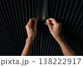 Cropped shot of professional arranging dark acoustic foam panels on a wall, installing soundproofing material for noise reduction in a creative studio or home environment. 138222917
