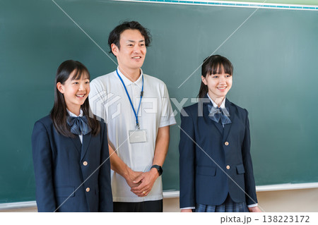 教室の黒板の前にいる男性教師と小学生,中学生,高校生の女子生徒 教室の黒板の前にいる男性教師と小学生,中学生,高校生の女子生徒 138223172