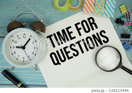Time For Questions text on a paper surrounded by office supplies, a magnifying glass, and a clock on a blue wooden surface Time For Questions text on a paper surrounded by office supplies, a magnifying glass, and a clock on a blue wooden surface 138223494