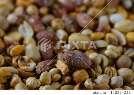 Vibrant mixture of seeds and grains captures the essence of a bountiful harvest in an outdoor market setting during a sunny afternoon Vibrant mixture of seeds and grains captures the essence of a bountiful harvest in an outdoor market setting during a sunny afternoon 138224238