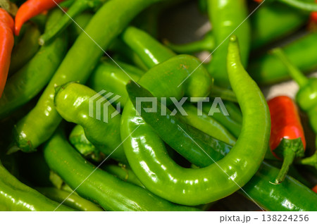 Bountiful harvest of vibrant green and red chili peppers from a local market in summer 138224256