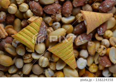 Crunchy snacks spread out on a colorful assortment of nuts perfect for sharing during festive gatherings Crunchy snacks spread out on a colorful assortment of nuts perfect for sharing during festive gatherings 138224358