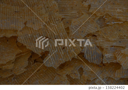Natural wax flakes scattered on a smooth surface, showcasing their textural beauty and warm hue in a cozy setting Natural wax flakes scattered on a smooth surface, showcasing their textural beauty and warm hue in a cozy setting 138224402