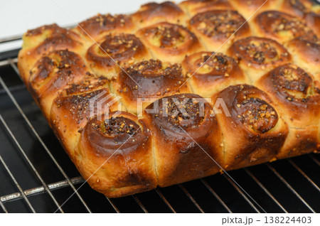 Baking a delicious homemade bread with a golden crust and sweet filling fresh out of the oven, perfect for any gathering or family meal Baking a delicious homemade bread with a golden crust and sweet filling fresh out of the oven, perfect for any gathering or family meal 138224403