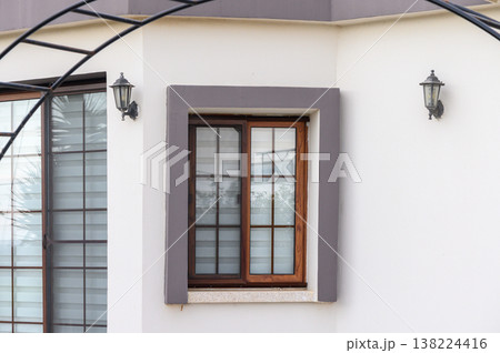 Charming wooden window framed by elegant architecture in a serene setting reflects peaceful outdoor ambiance Charming wooden window framed by elegant architecture in a serene setting reflects peaceful outdoor ambiance 138224416