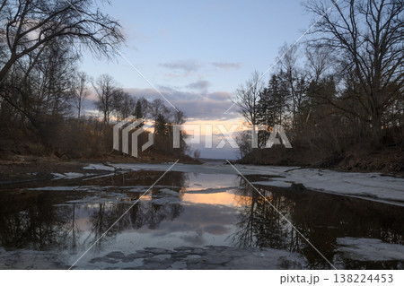 Serene twilight over a tranquil river reflecting the soft hues of dusk in early spring Serene twilight over a tranquil river reflecting the soft hues of dusk in early spring 138224453