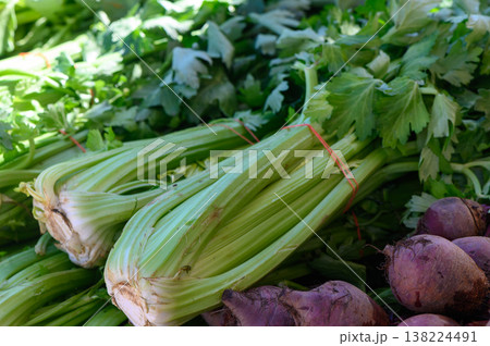 Freshly harvested celery and beets at a vibrant farmers market showcasing local produce in the warm afternoon sun Freshly harvested celery and beets at a vibrant farmers market showcasing local produce in the warm afternoon sun 138224491