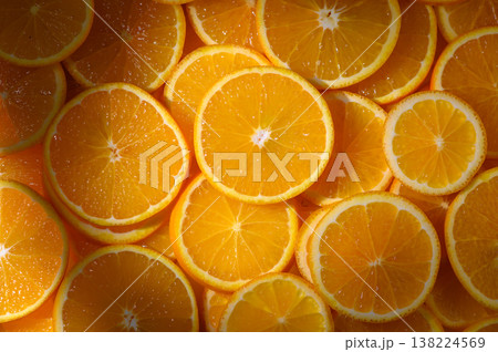 Vibrant orange slices arranged artistically in natural light, capturing bright freshness and deliciousness 138224569