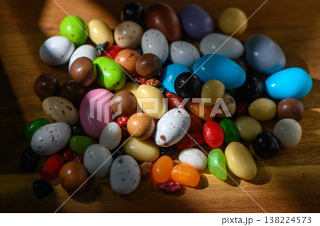 Colorful candy assortment scattered on a wooden surface during spring festivities Colorful candy assortment scattered on a wooden surface during spring festivities 138224573
