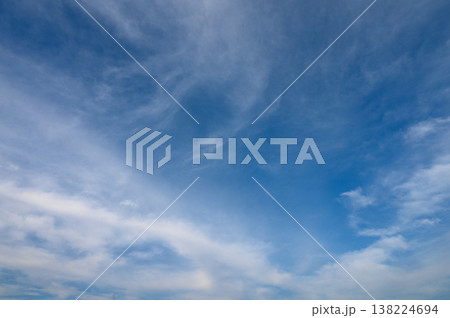 Expansive blue sky adorned with wispy clouds on a tranquil day Expansive blue sky adorned with wispy clouds on a tranquil day 138224694