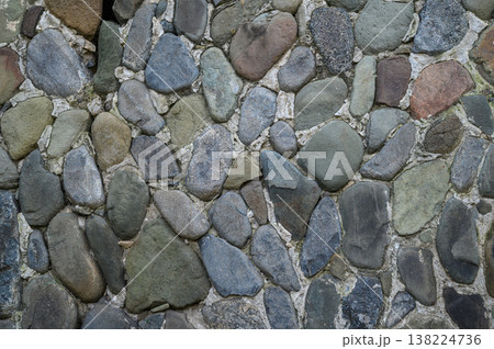 Natural stone wall creates rustic charm in a serene garden setting at dusk Natural stone wall creates rustic charm in a serene garden setting at dusk 138224736