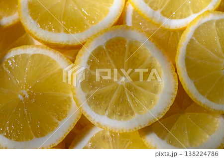 Bright slices of lemon arranged in a vibrant, refreshing pattern for culinary Bright slices of lemon arranged in a vibrant, refreshing pattern for culinary 138224786