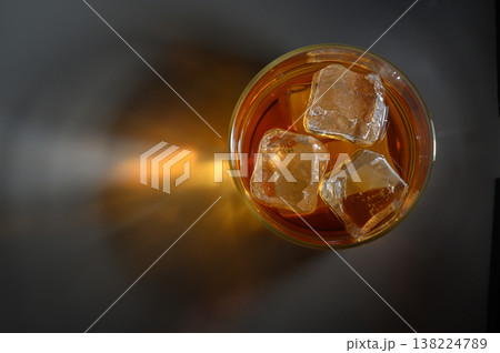 Refreshing iced tea in a clear glass on a dark surface, capturing the essence 138224789