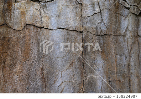 Textured stone wall displaying natural patterns and earthy tones in a rustic 138224987
