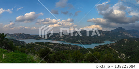 Serene lake view with rolling hills under a dreamy sky in early evening light Serene lake view with rolling hills under a dreamy sky in early evening light 138225084